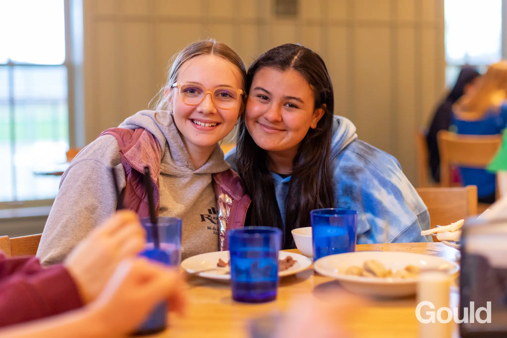 Two students smiling in dining room